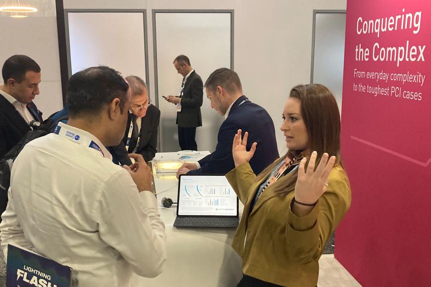 Multiple people at a conference booth