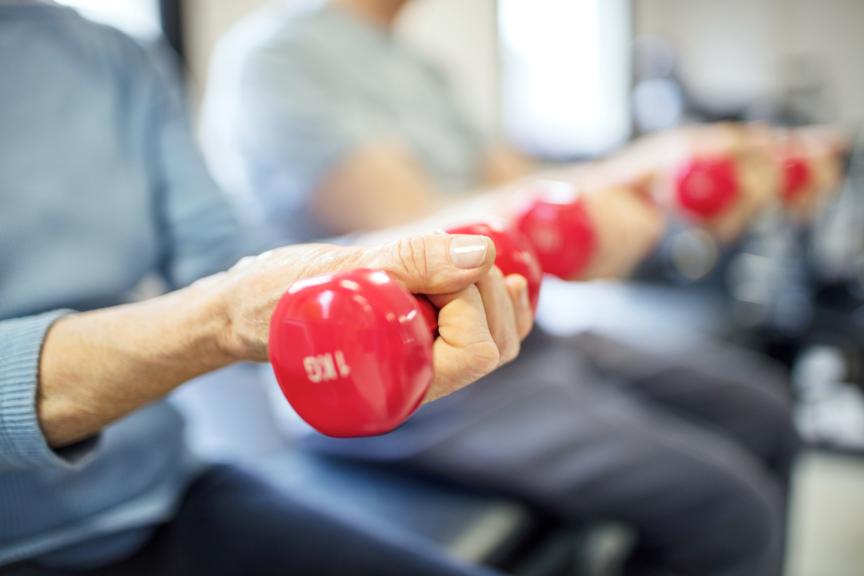 Elder hand holding a gym weight